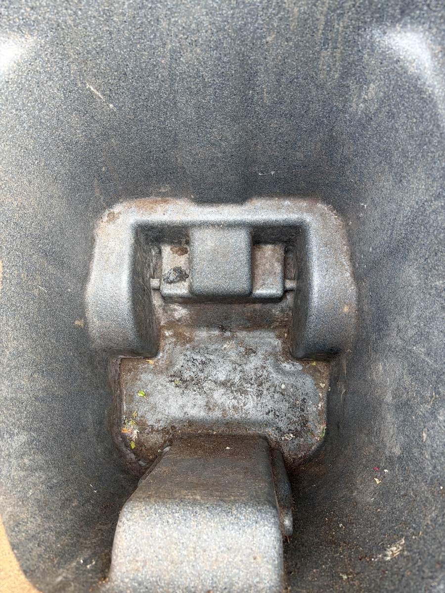 Grimy garbage bin lid caked with residue before Eco Pro Wash cleaning